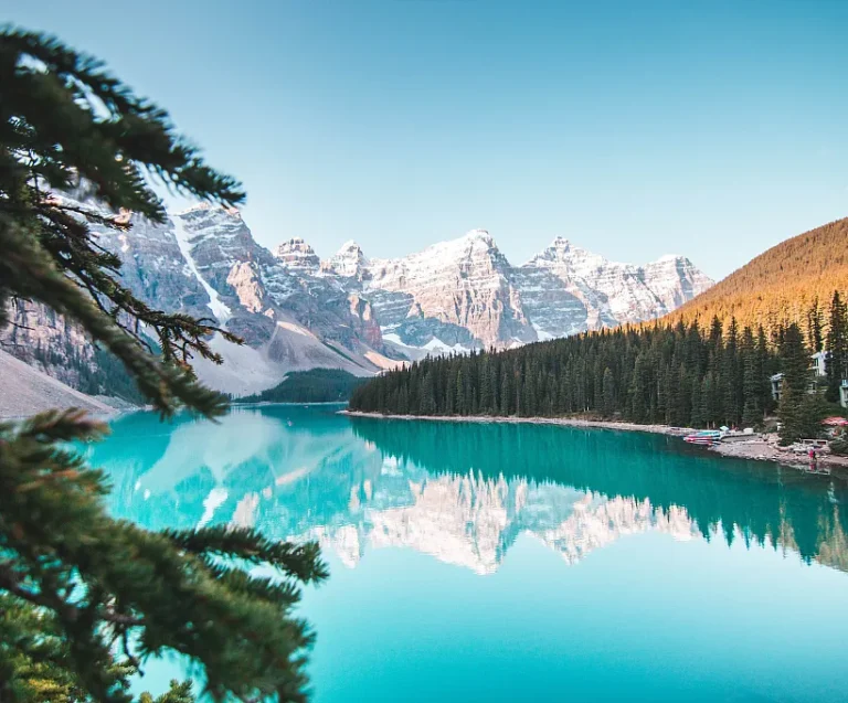 A picturesque scene of Moraine Lake, nestled in Banff National Park, Canada, with vibrant blue water and rugged mountains.