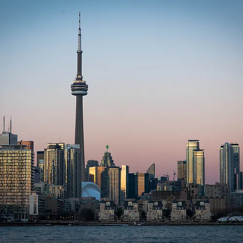 A vibrant city skyline is visible in the background, highlighting the architectural diversity of the urban environment.
